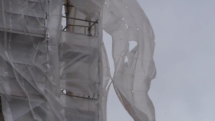 Construction scaffolding in a strong wind.