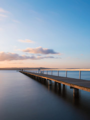 Fototapeta premium An empty long jetty view during sunset.