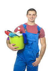 Young man with cleaning supplies on white background
