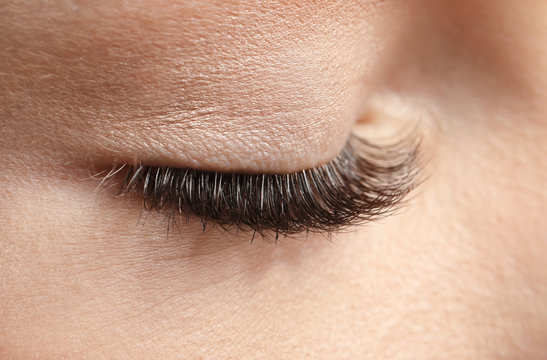 Closed female eye with long eyelashes, closeup