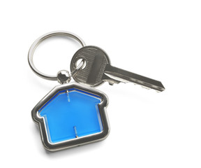 Key with trinket in shape of house on white background