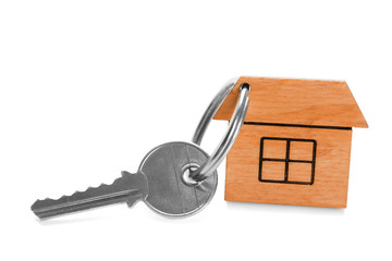 Key with trinket in shape of house on white background