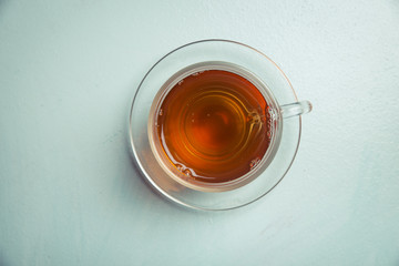 Cup with green tea on grey wooden background