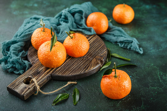 Tangerines oranges, mandarins, clementines, citrus fruits with leaves