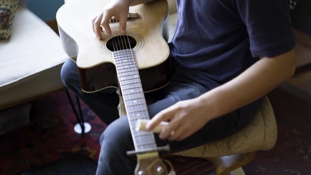 Looking down on a beater slide guitar with pvc sider.