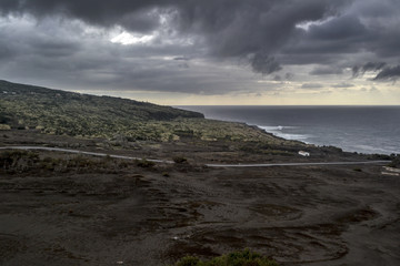 a road leading to a white house on the deserted coast of the volcanic faial island of the Azores