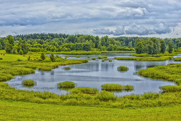Travel Concepts and Ideas. Belarussian National Park Braslav Lakes Surrounded by Densely Forested Area at Noon During Summertime.