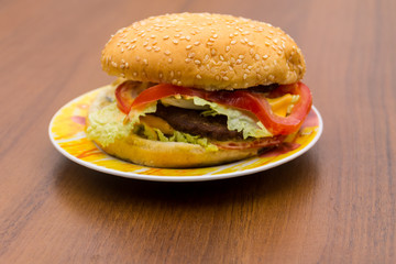 Delicious hamburger or sandwich on plate on wooden table