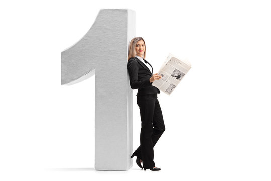 Elegant woman with a newspaper leaning against a cardboard number one