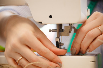 Obraz na płótnie Canvas Woman seamstress work on sewing machine