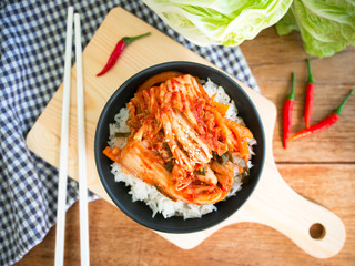 Kimchi on rice, traditional Korean food in top view.