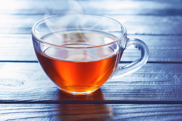 Glass cup of hot tea in the morning coldness