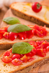 Bruschetta bread with basil and chopped tomatoes. 