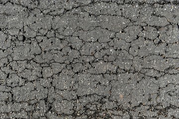 detail surface of broken asphalt road in countryside