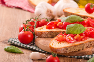Bruschetta bread with basil and chopped tomatoes. 