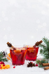 Christmas mulled wine and ingredients. On white snow background with copyspace