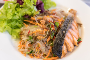 salmon with spicy vermicelli and another seafood, thai mix  Western food  on white plate