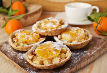 Homemade fruit tarts with caramelized apple and tangerine.