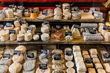 Fotobehang Different cheeses on the counter of a small store at the Aligre Market. Paris, France © Aliaksandr Kazlou