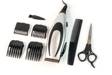 The machine for a hairstyle with attachments, comb and scissors.
