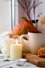 Cup of tea and bread near the window. Lifestyle of the autumn. Pumpkin