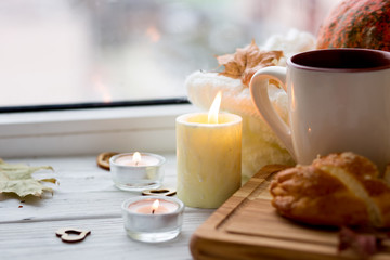 Cup of tea and bread near the window. Lifestyle of the autumn. Pumpkin