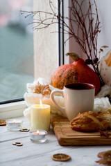 Cup of tea and bread near the window. Lifestyle of the autumn. Pumpkin