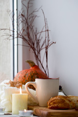 Cup of tea and bread near the window. Lifestyle of the autumn. Pumpkin
