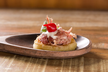 blinis of puba dough, smoked meat, coriander and minced pepper