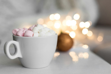 Fototapeta na wymiar Cup of hot chocolate and marshmallow in the background of Christmas decorations.