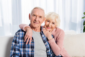 portrait of happy senior husband and wife looking at camera