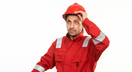 Young engineer worker in a red helmet