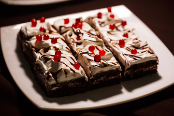 chocolate cakes with butter cream decorated with red jelly berries