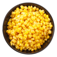 Corn seeds on black plate isolated on white background. Top view.