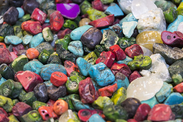 Fototapeta na wymiar Background of colored stones of ordinary and semi-precious