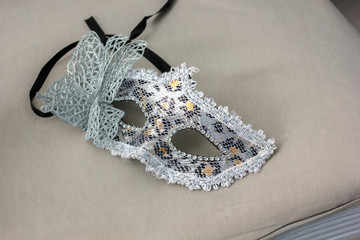 Carnival maks for masquerade over the white chair.