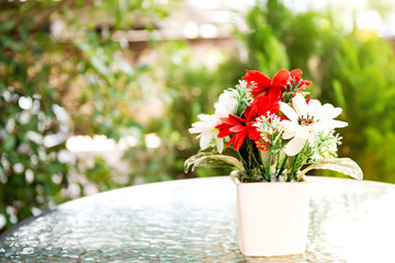 Decoration artificial flower in the pot on table