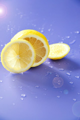 Pieces of Fresh Lemon with Lighting on Background