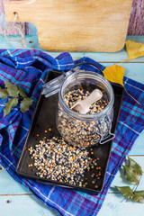 Lentils mix in the jar and tray. Blue wooden table and background.