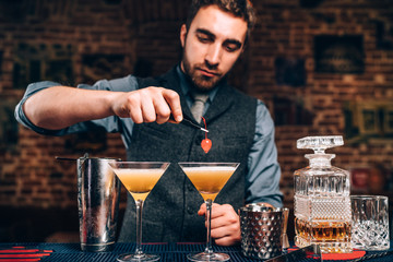 Portrait of barman preparing drinks in nightclub.