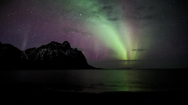 Northern lights aurora borealis time lapse over ocean, Eystra Horn, Stokksnes, Hofn, Iceland, 4k