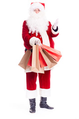 Portrait of Santa Claus posing with bunch of shopping bags on white background
