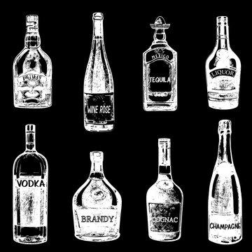 Set of hand drawn sketch style bottles of alcohol. Vector illustration isolated on black background.