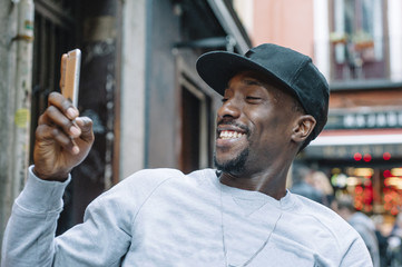 young  man of color  using the phone