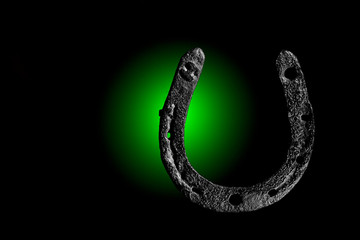 HorseShoe rusty steel on dark background