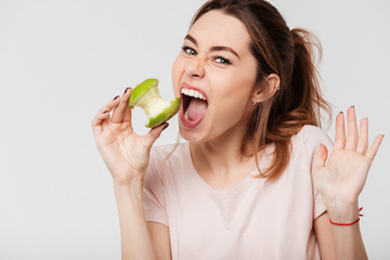 Close up portrait of a pretty girl biting an apple