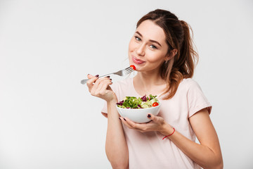 Portrait of a lovely pretty girl eating fresh salad