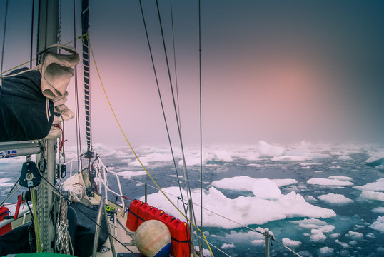 Greenland, arctic: sailing boat trough the iceberg, risk, danger