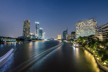 Fototapeta na wymiar Abstract blurred Background of Light effects over time after sunset on the river : Bangkok city, Hotel and resident area in capital of Thailand