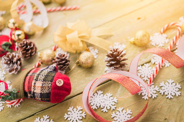 festive background concept with christmas decorating items on wooden background with light filter